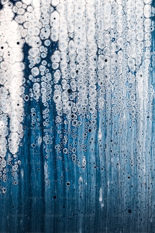 a blue and white background with water drops