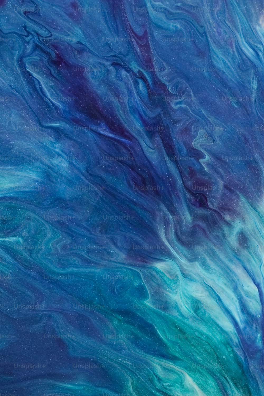 an abstract painting of blue and green colors