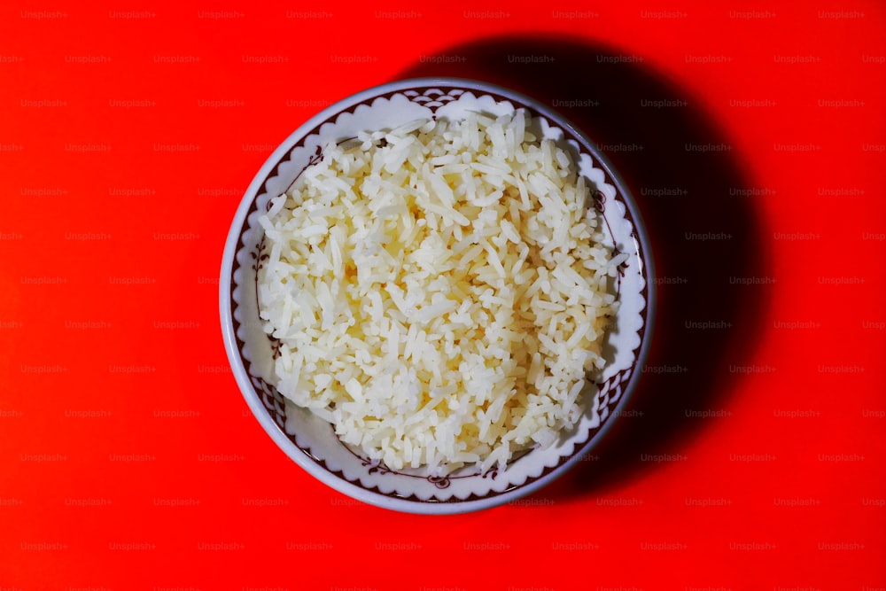 eine Schüssel Reis auf roter Fläche