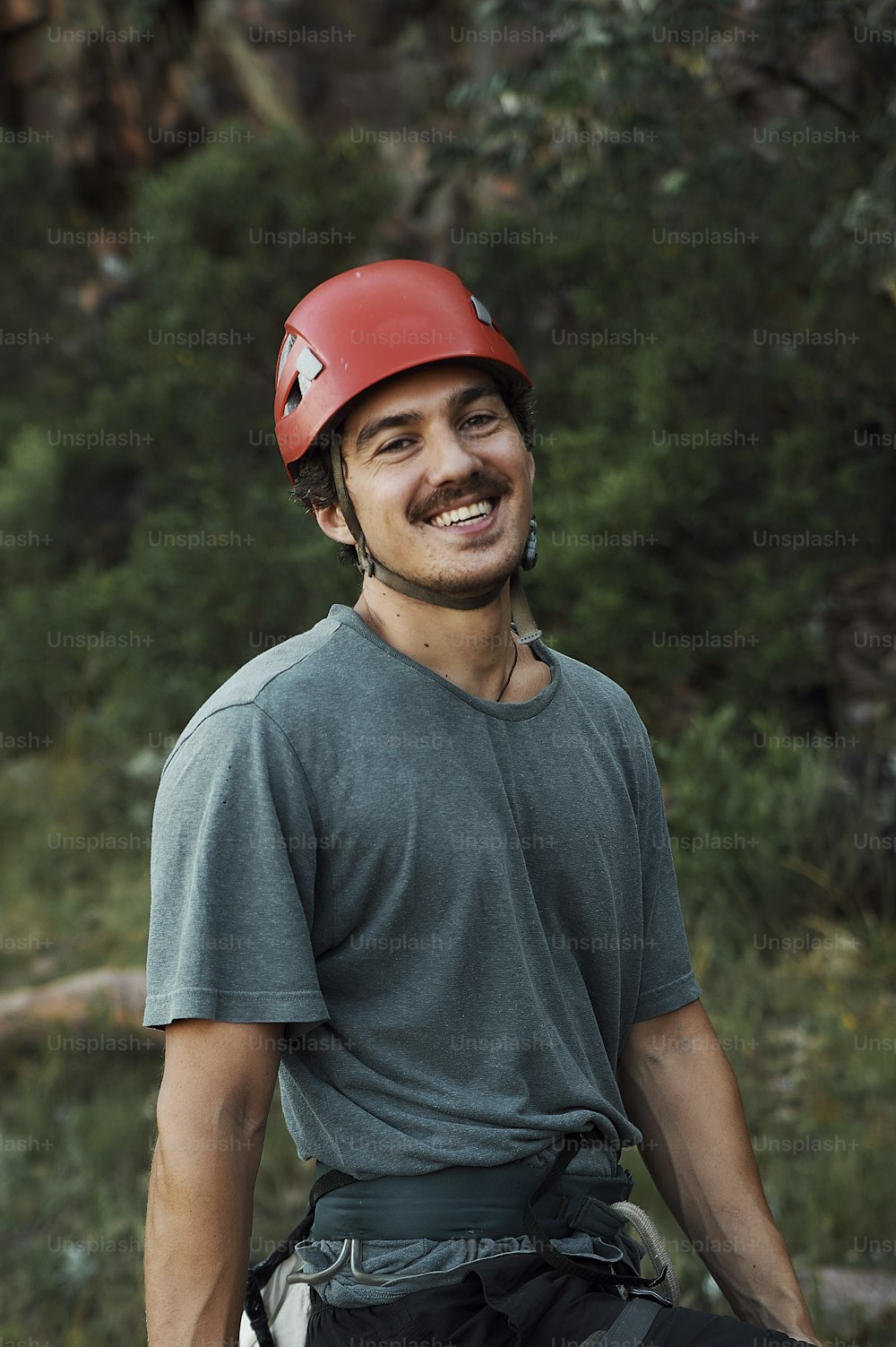 a man wearing a helmet and climbing gear