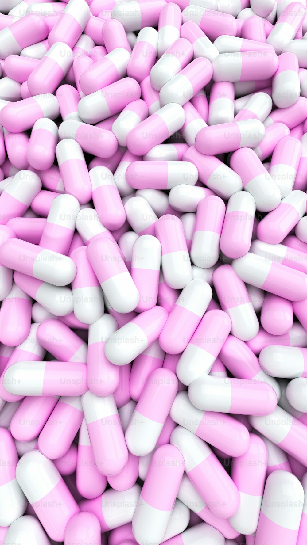 Una gran pila de píldoras rosadas y blancas