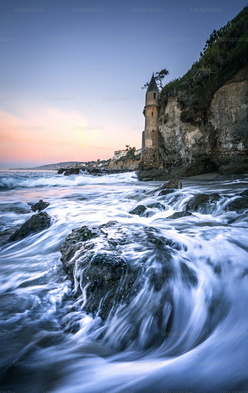 a large body of water near a rocky shore