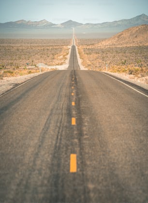an empty road in the middle of the desert