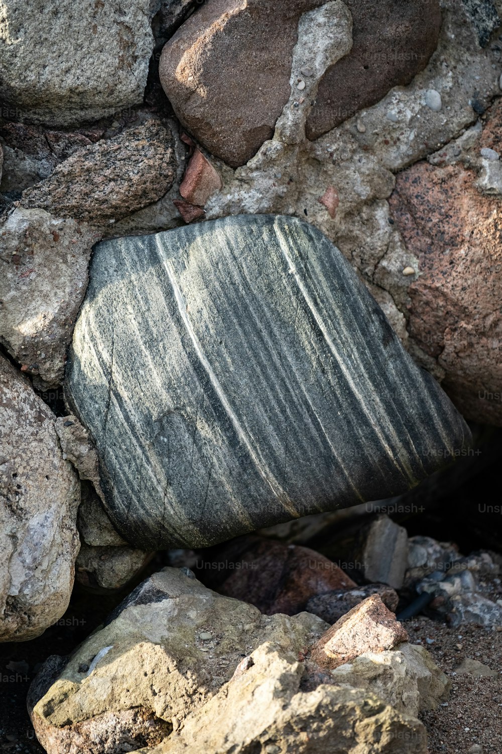 a rock sitting on top of a pile of rocks