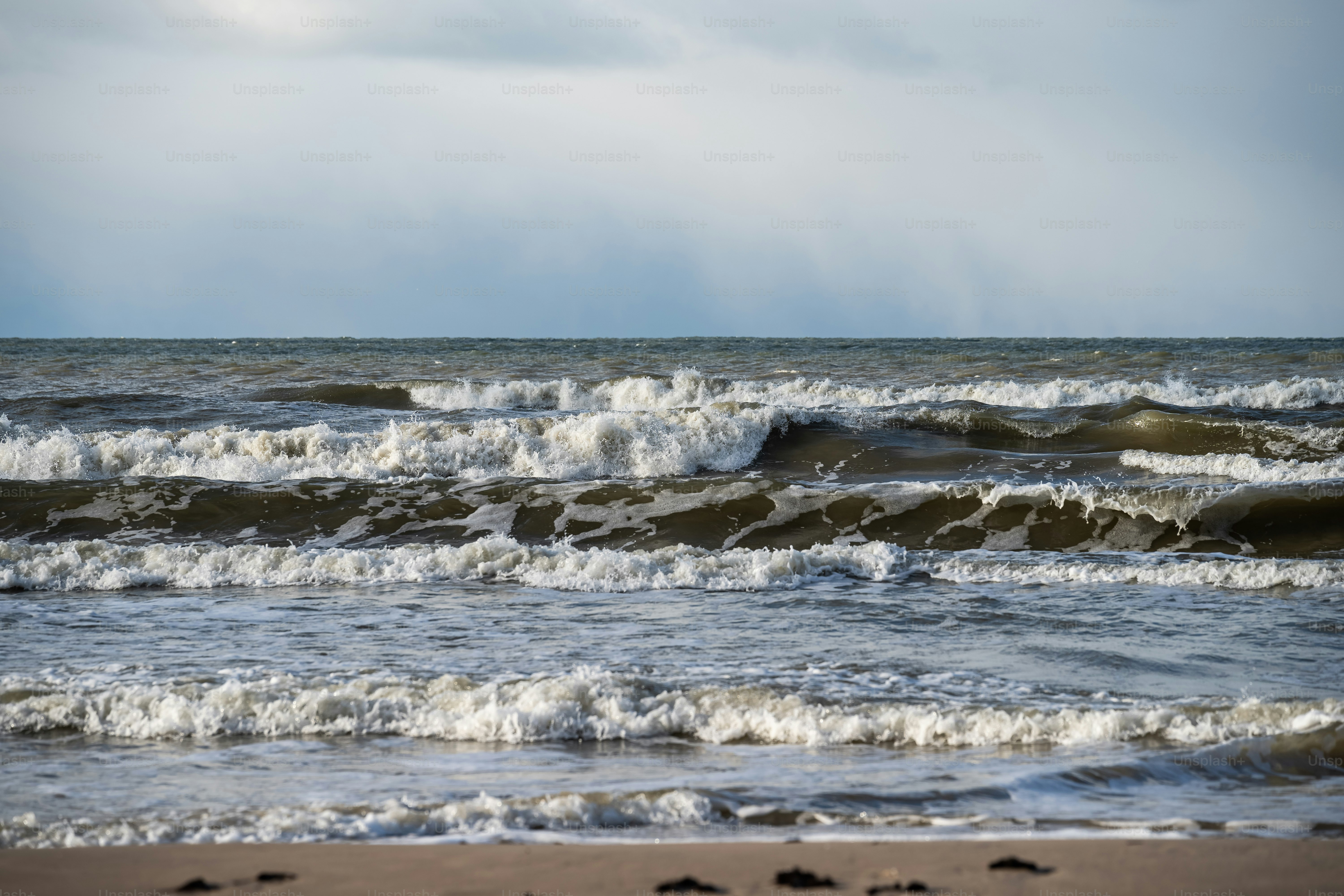 a beach with waves coming in and out of the water