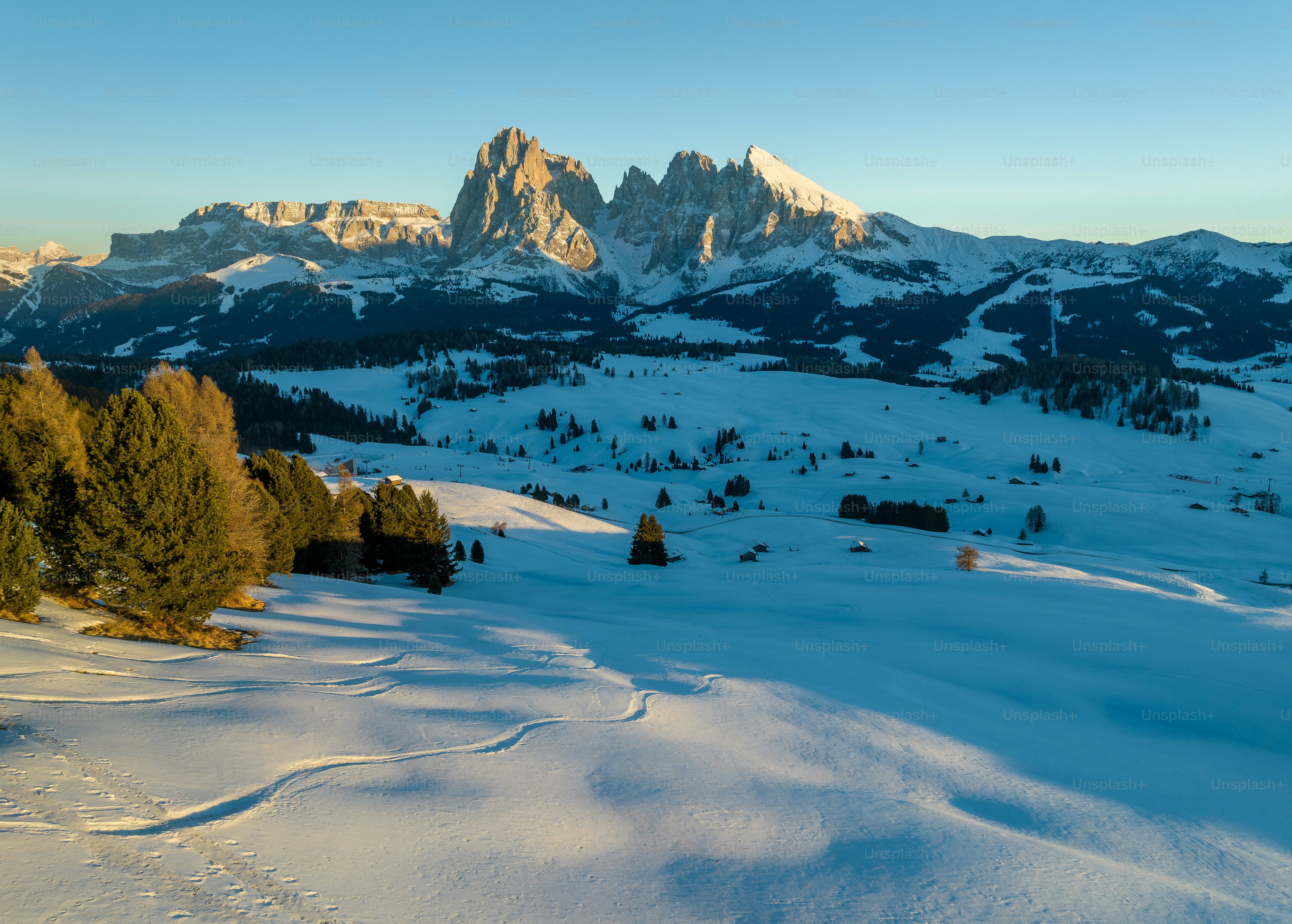 The sun is shining over a snowy mountain photo – Backgrounds Image on ...