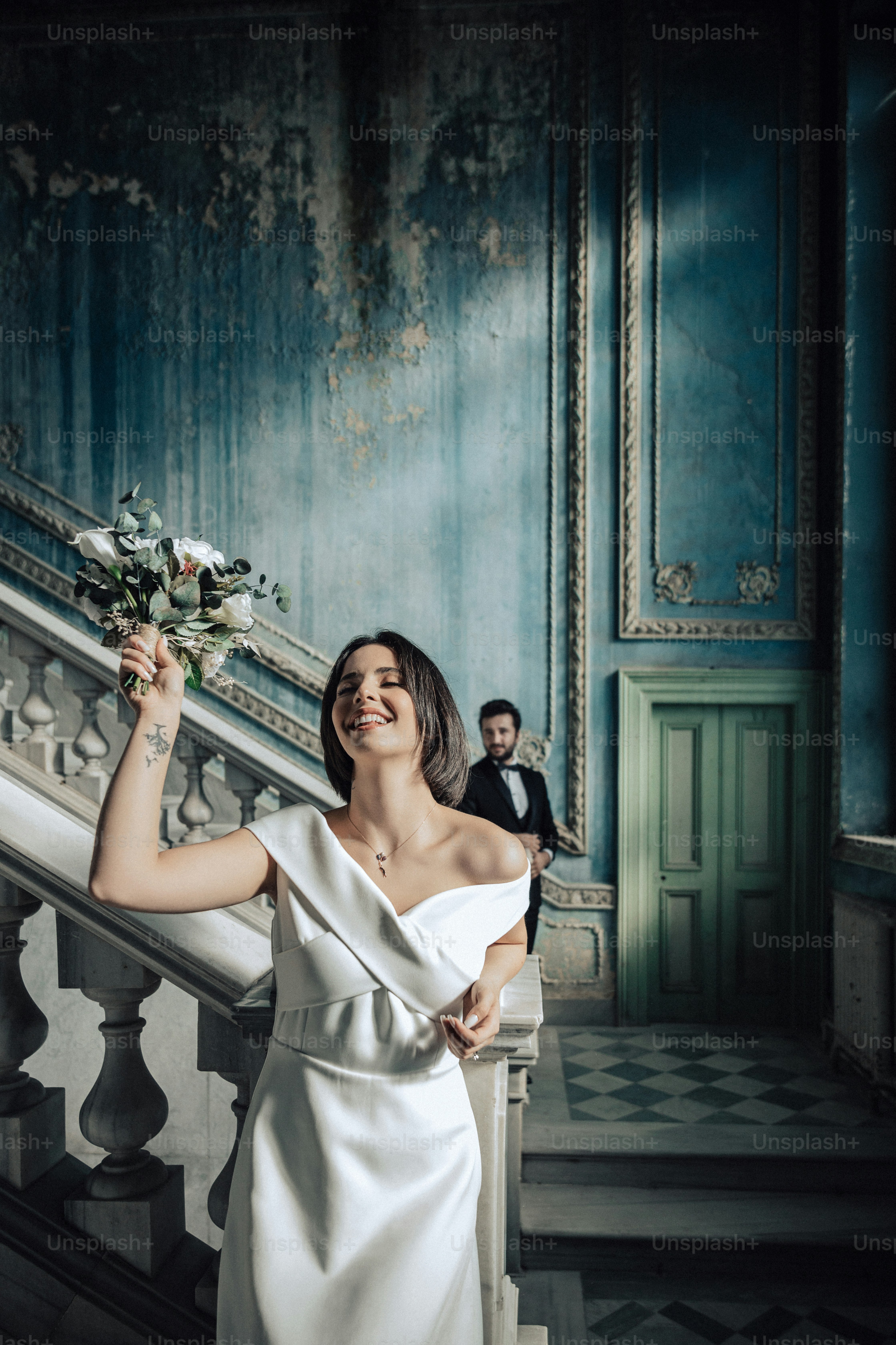 a woman in a white dress holding a bouquet of flowers