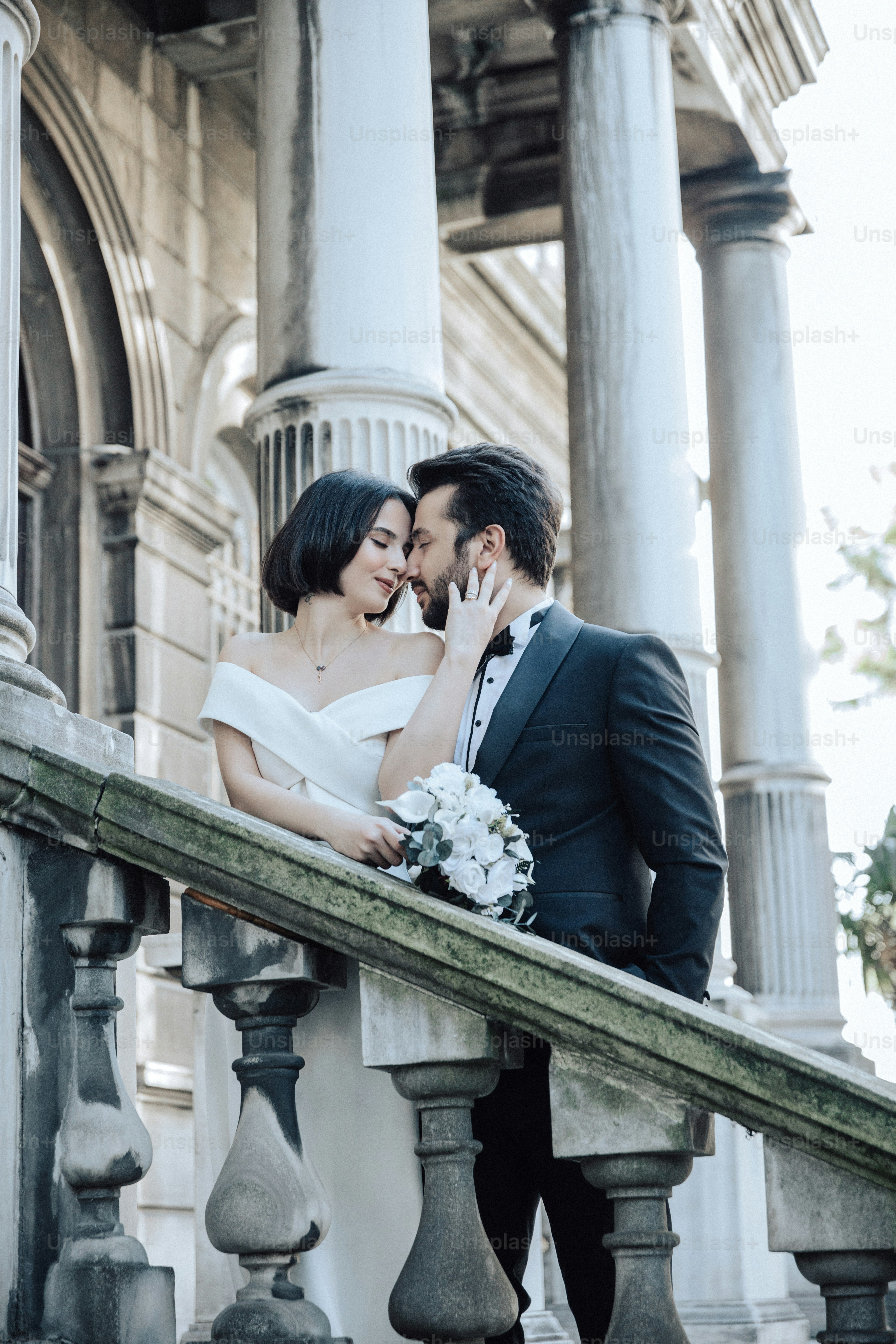 a man and a woman standing on a balcony next to each other