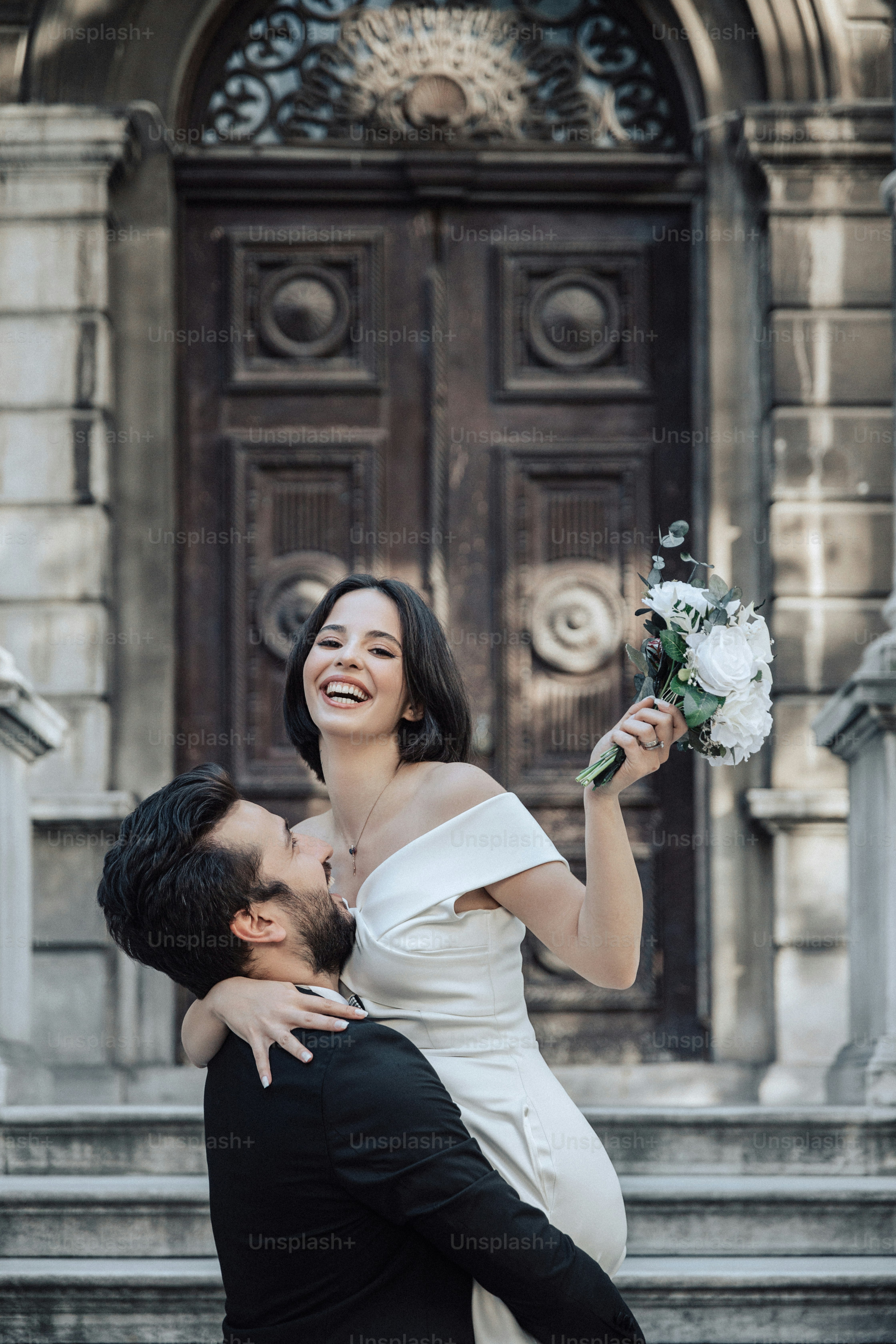 a man holding a bouquet of flowers next to a woman