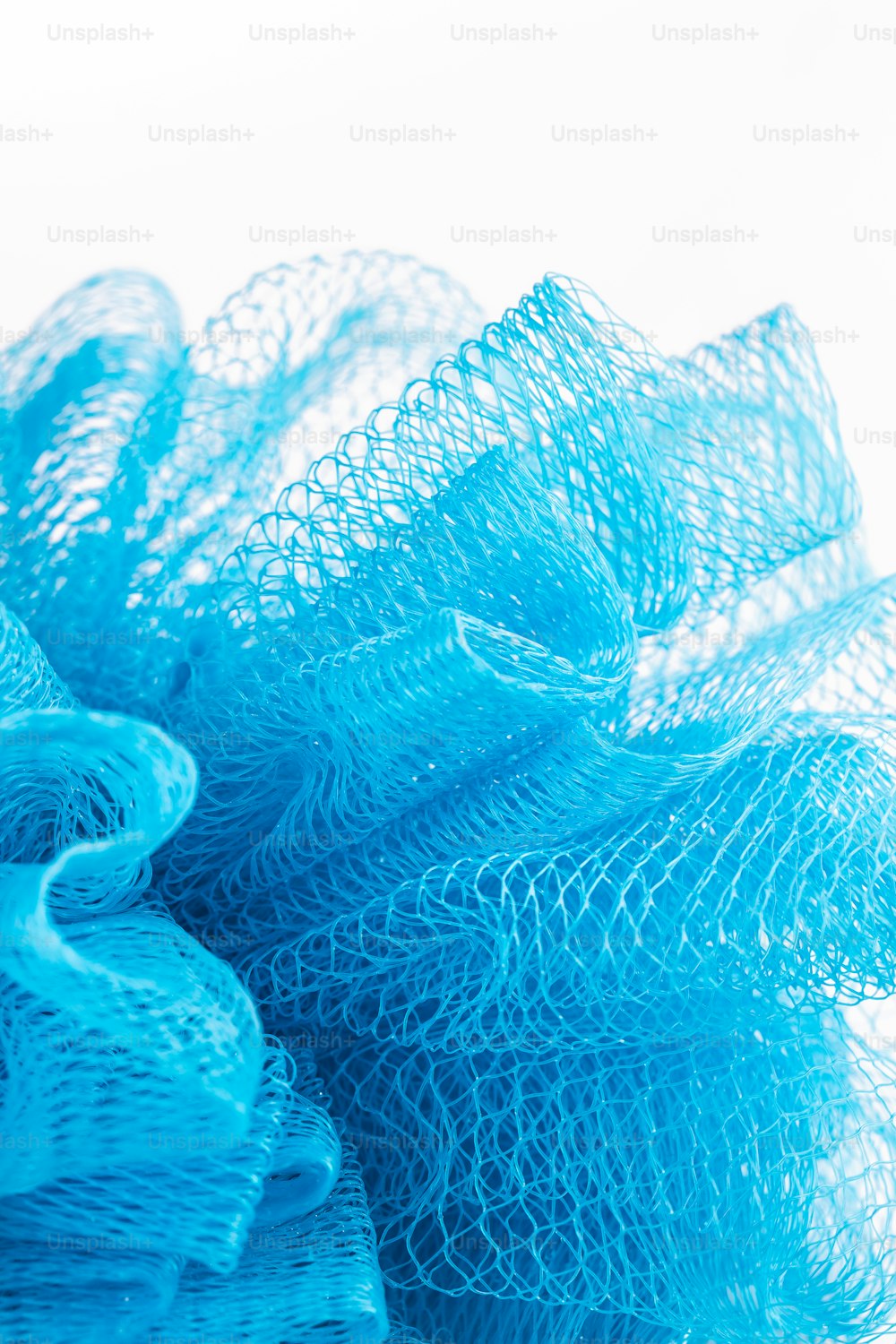 a pile of blue mesh sitting on top of a white table