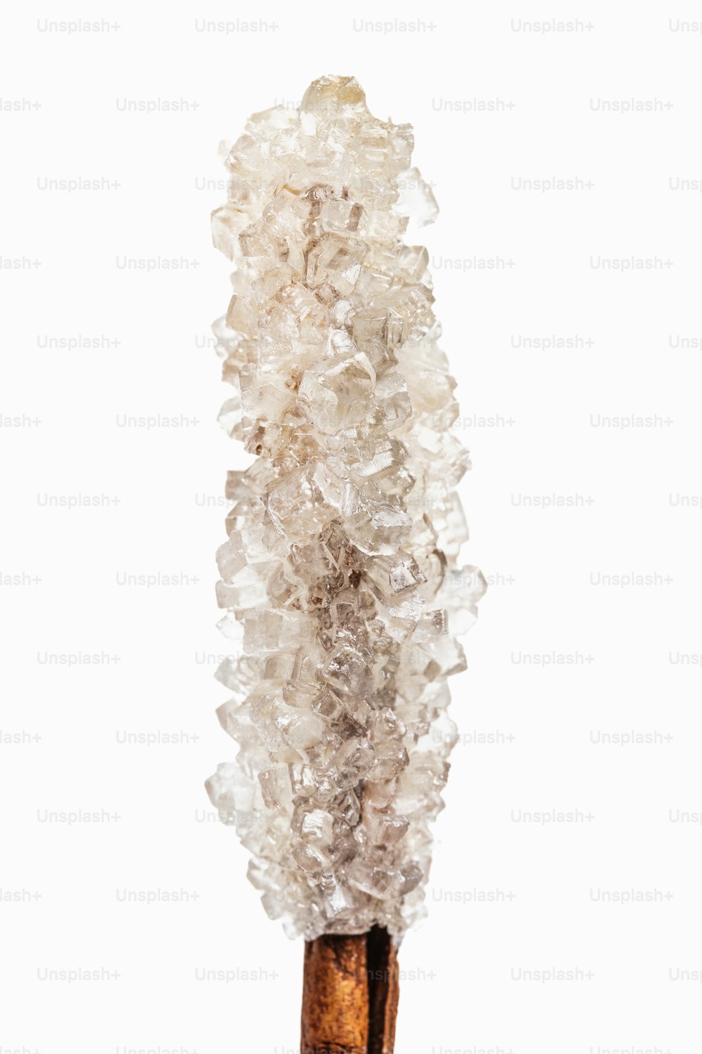 a tall piece of glass sitting on top of a wooden stick