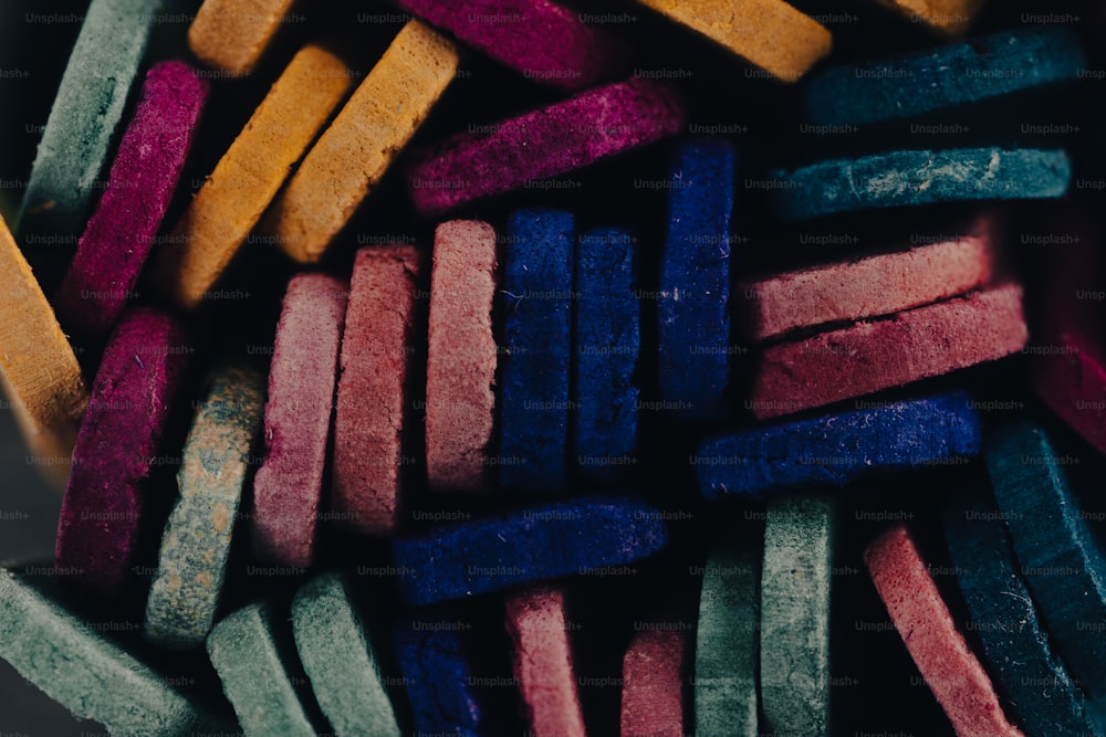 a close up of a bowl of colored crayons