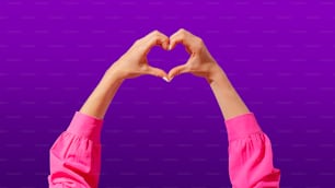 a person making a heart shape with their hands