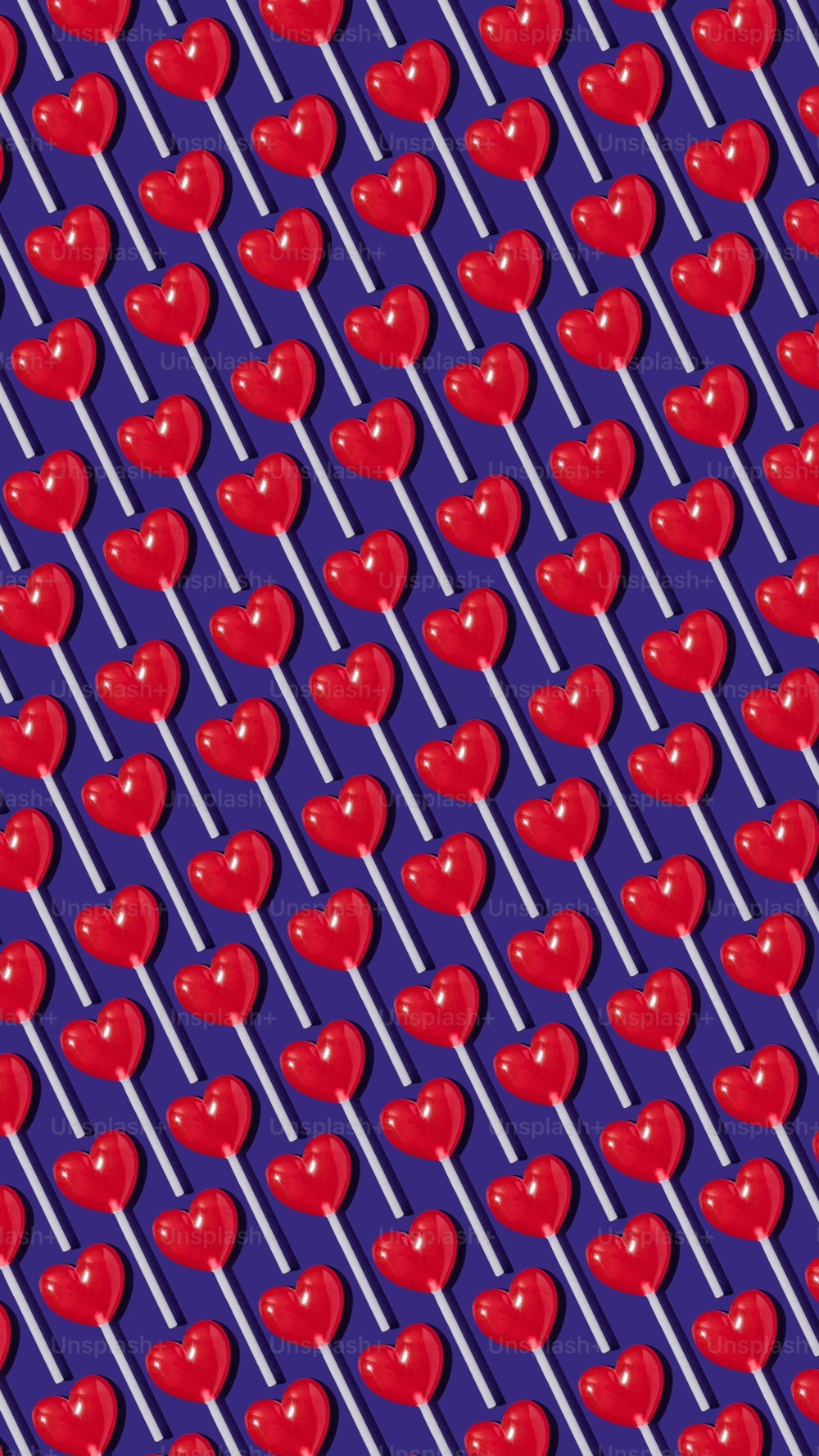 a pattern of red apples on a purple background