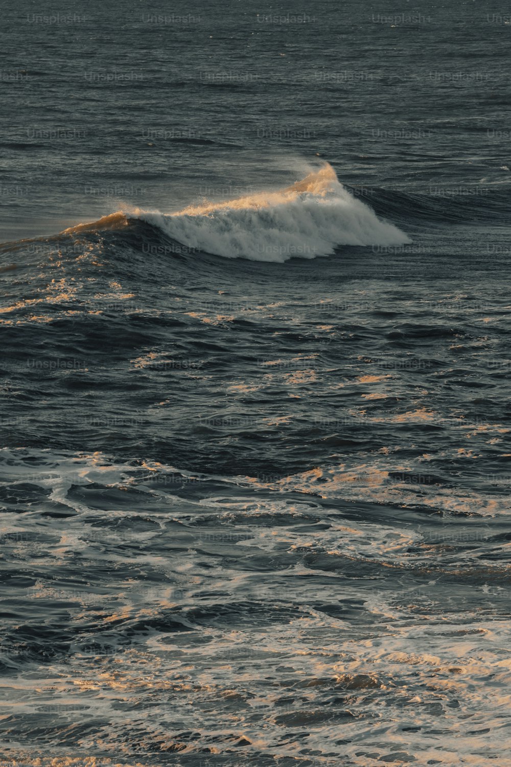 a person riding a surfboard on a wave in the ocean