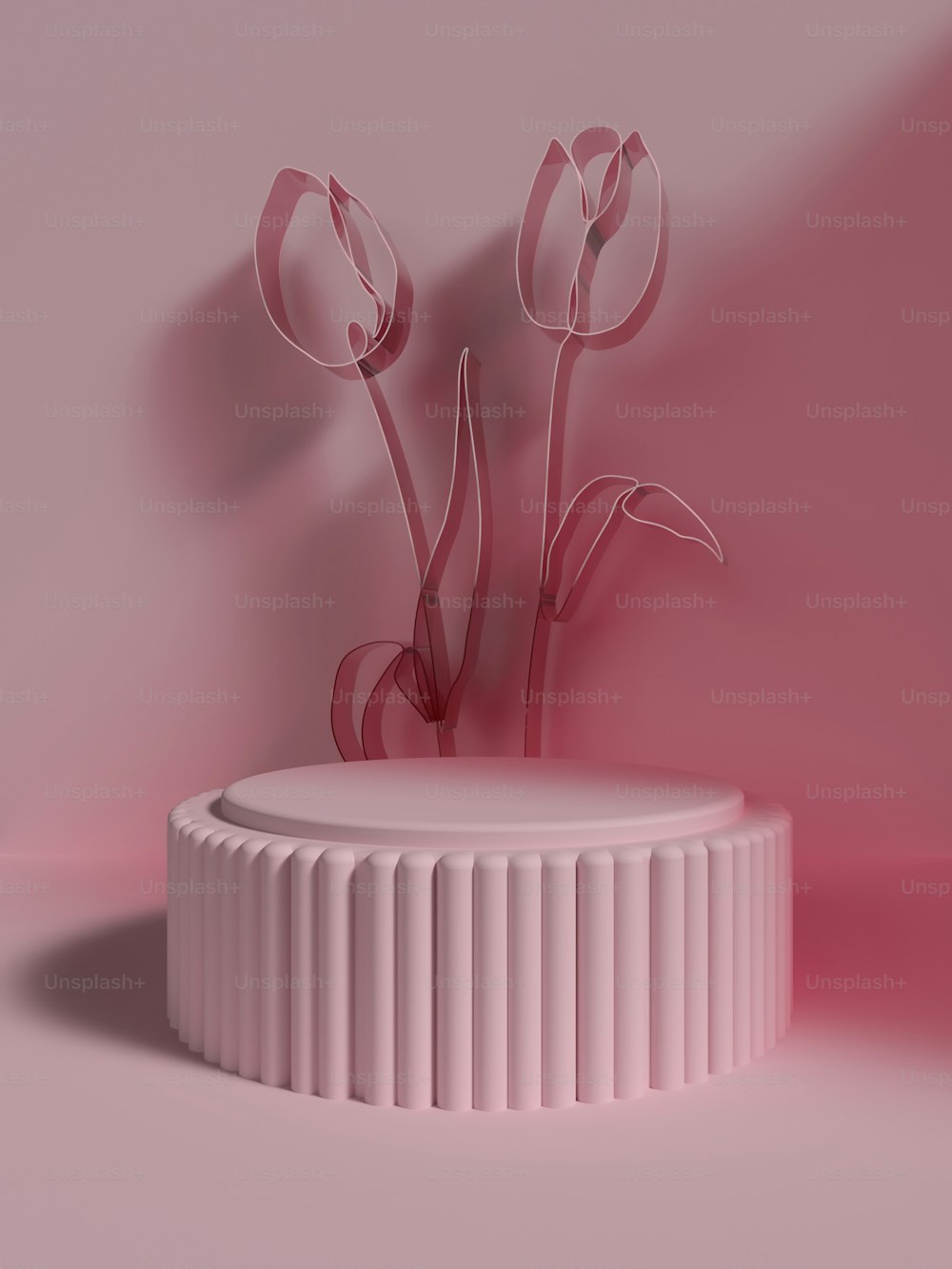 a pink vase with three flowers in it