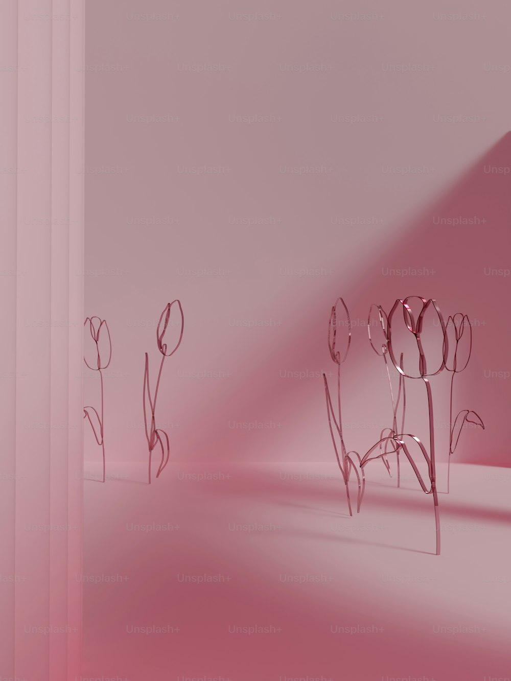a pink room with flowers in the corner