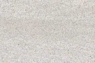 a close up of a white surface with small speckles