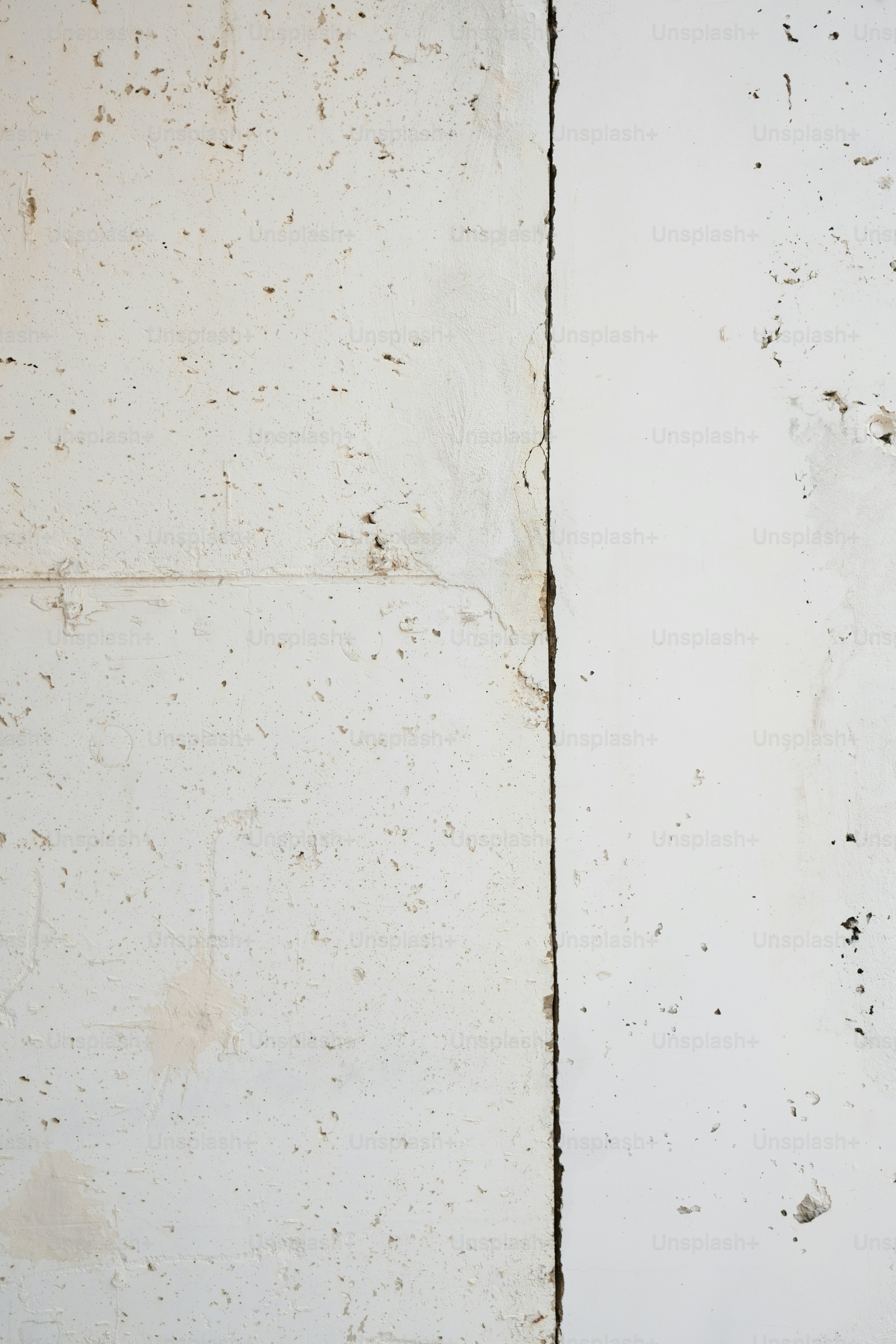 a white wall with peeling paint on it