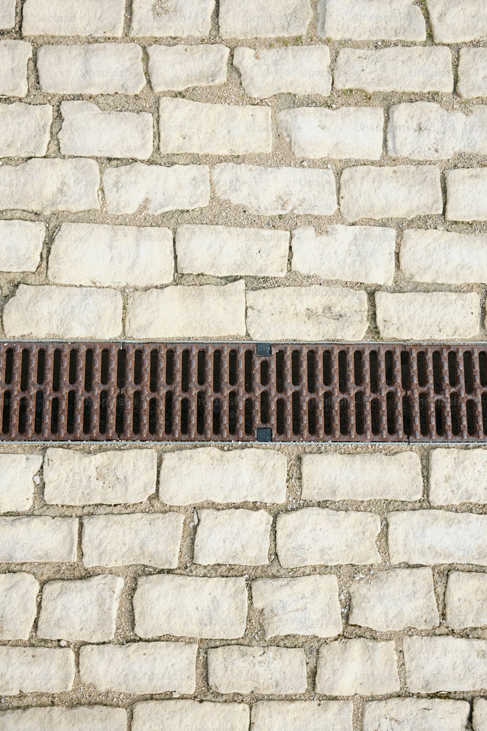 a manhole cover on a cobblestone street