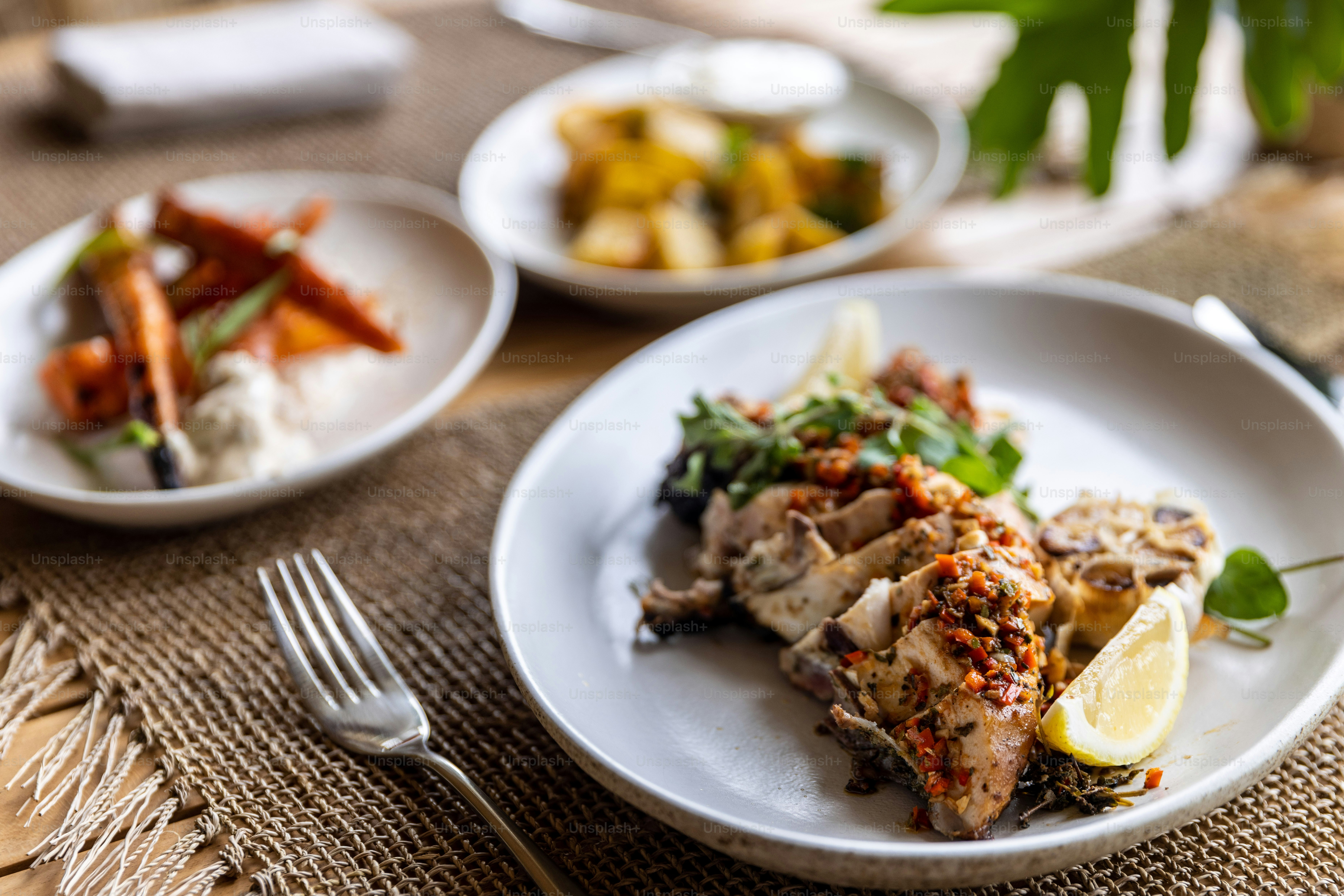 a white plate topped with meat and vegetables