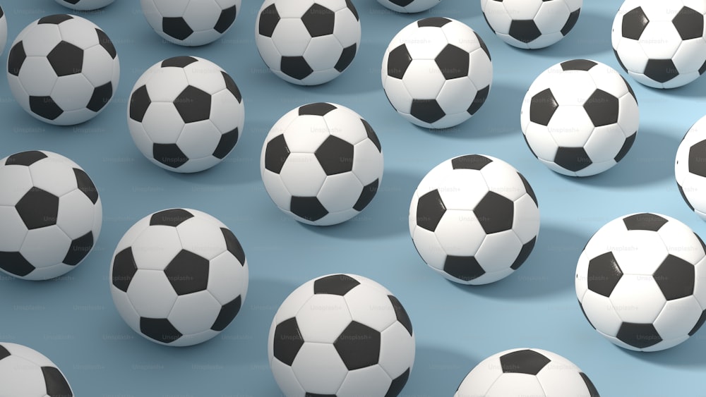 a group of soccer balls sitting on top of a blue surface