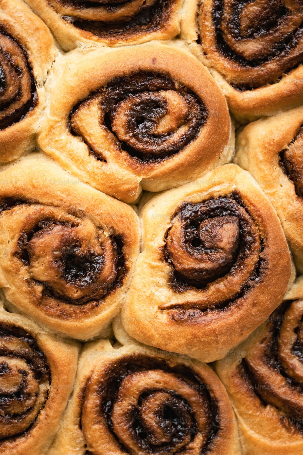 a close up of a bunch of cinnamon rolls