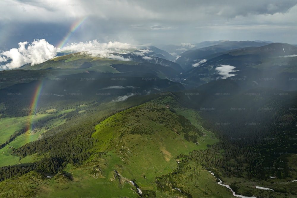 a rainbow in the sky over a mountain range