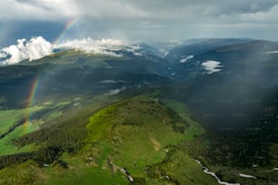 a rainbow in the sky over a mountain range