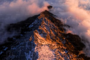 the top of a mountain covered in clouds