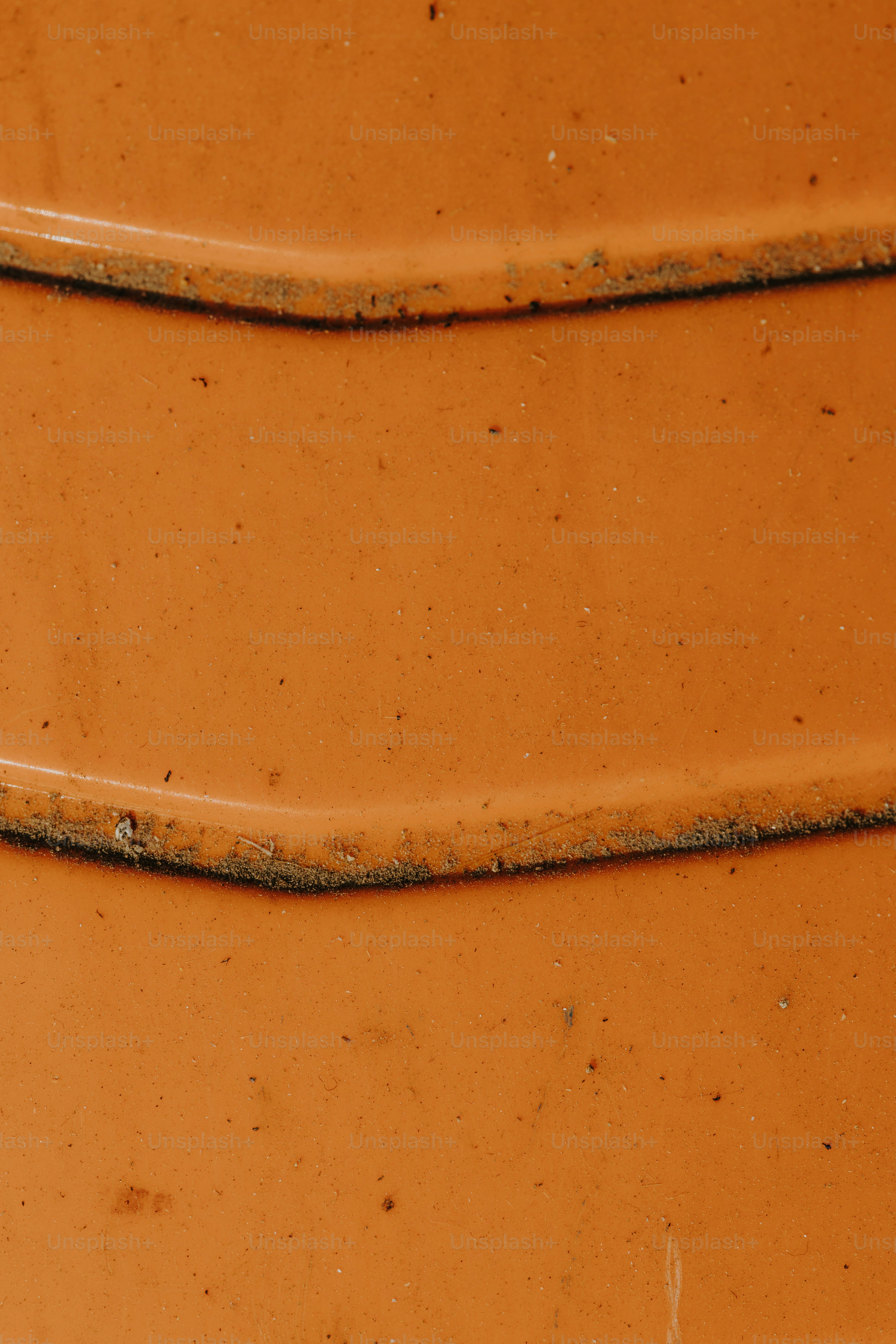 a close up of a large orange vase