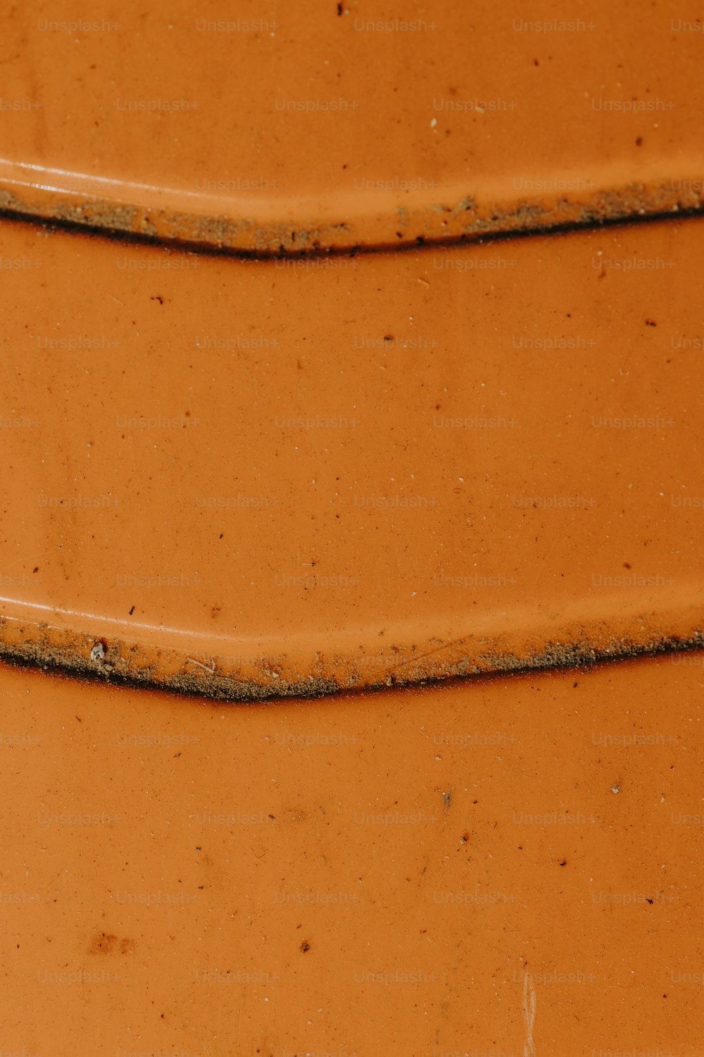 a close up of a large orange vase