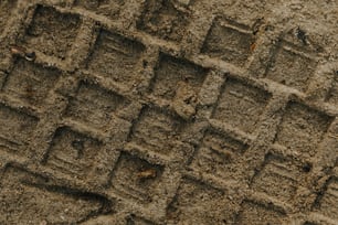 a close up of a piece of dirt with small squares on it