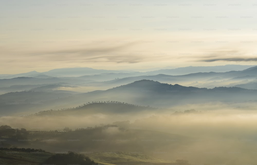 a view of a mountain range covered in fog