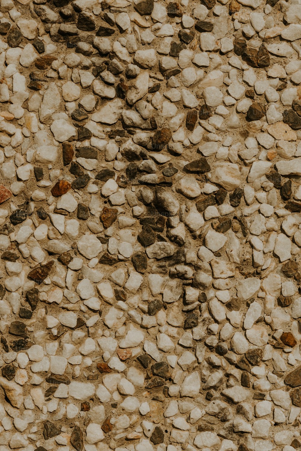 a close up of a stone wall with rocks on it