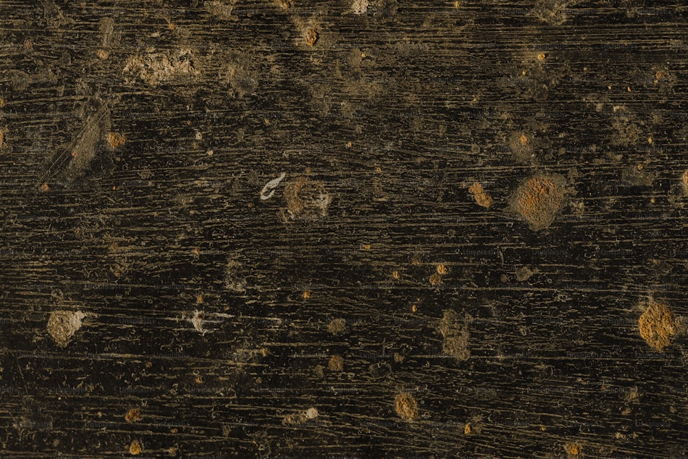 a close up of a wooden surface with a clock on it