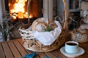 a basket filled with bread next to a cup of coffee