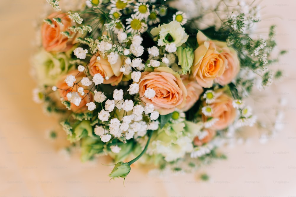 a bridal bouquet of peach roses and baby's breath