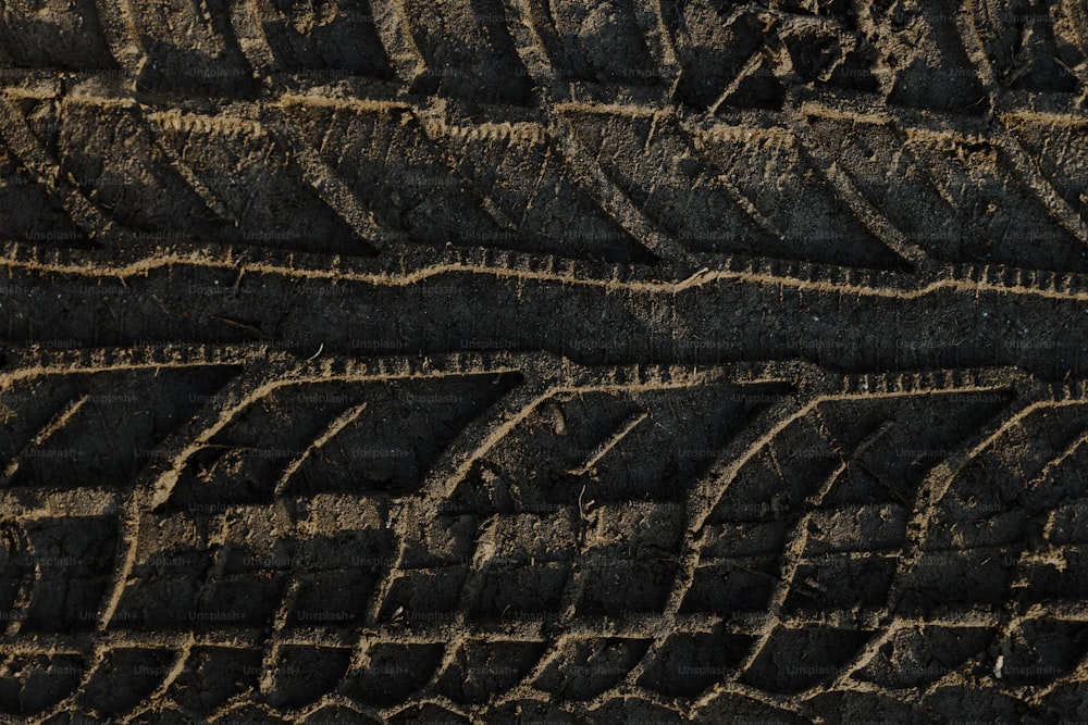 a close up of a tire on a dirt road