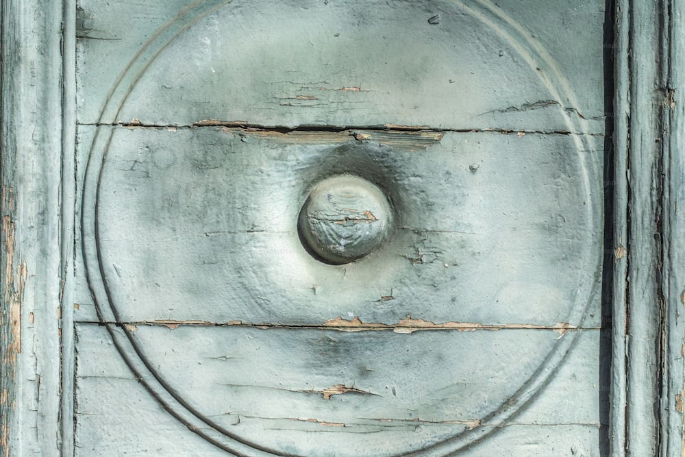 a close up of a metal door with a circular design