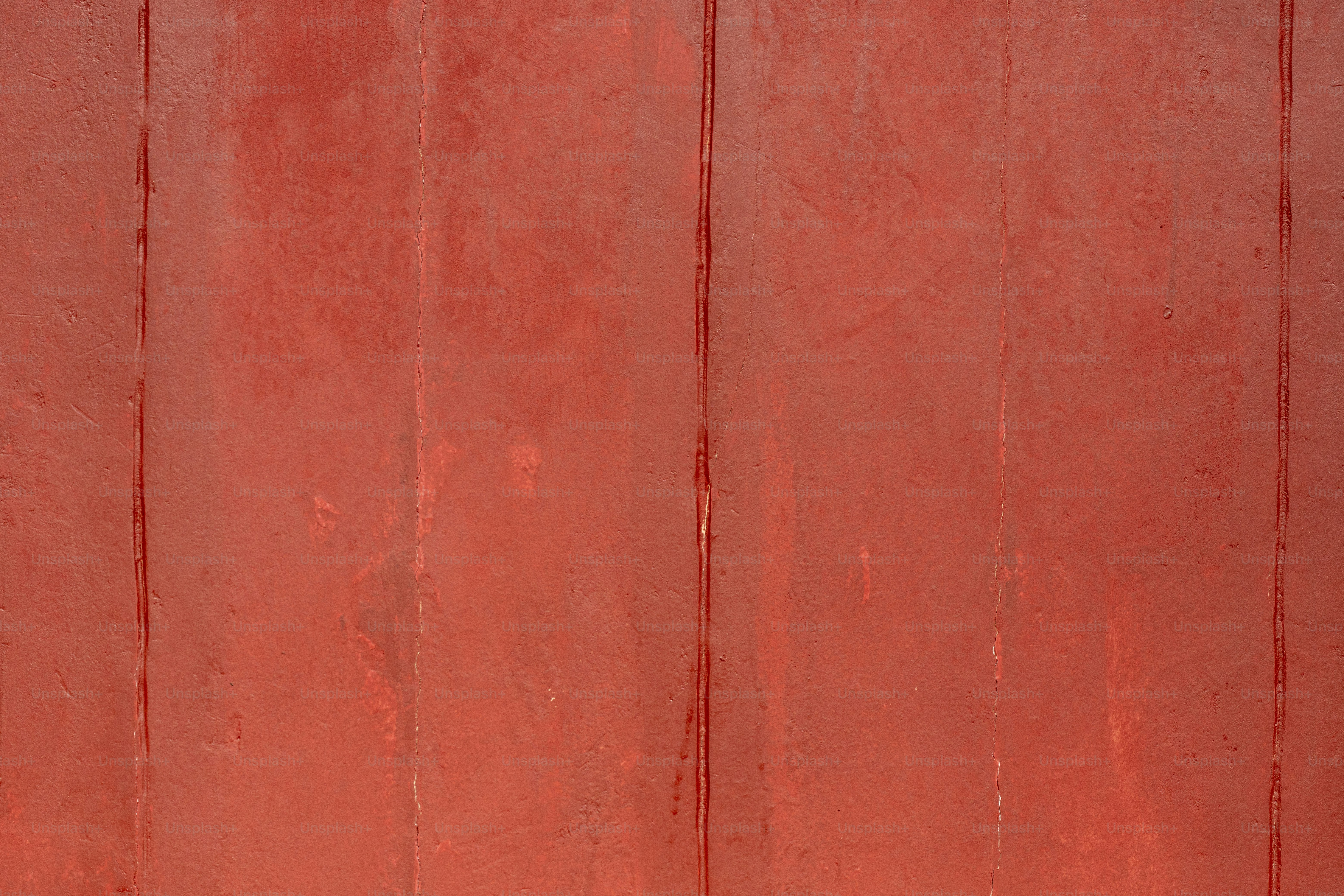 a red wall with a clock on it