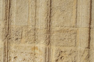 a close up of a stone wall with a clock on it