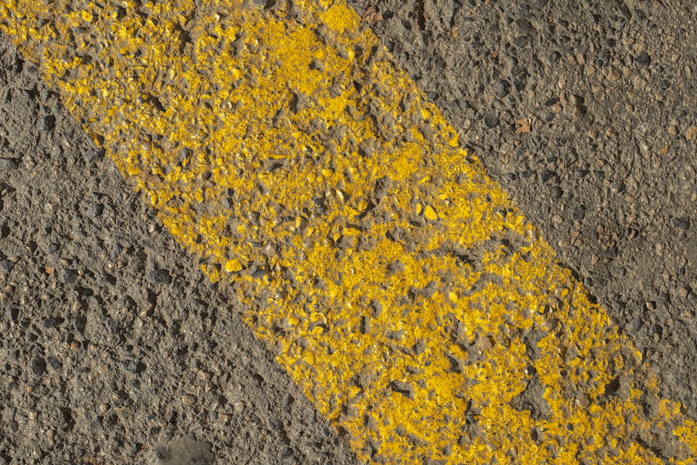 a yellow line painted on the side of a road