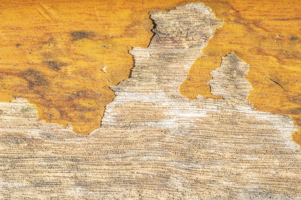 a piece of wood with peeling paint on it
