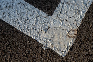 a white arrow painted on a black ground