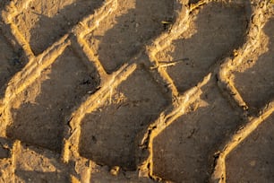 a close up of a brick pattern made of dirt