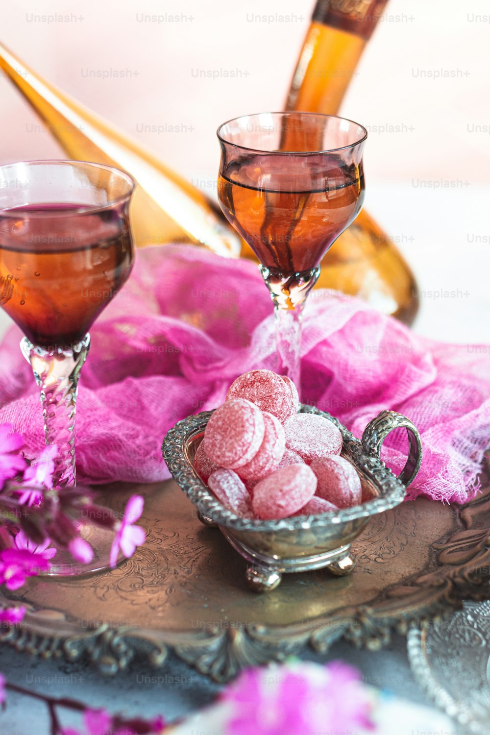 two glasses of tea and a bowl of powdered sugar on a tray