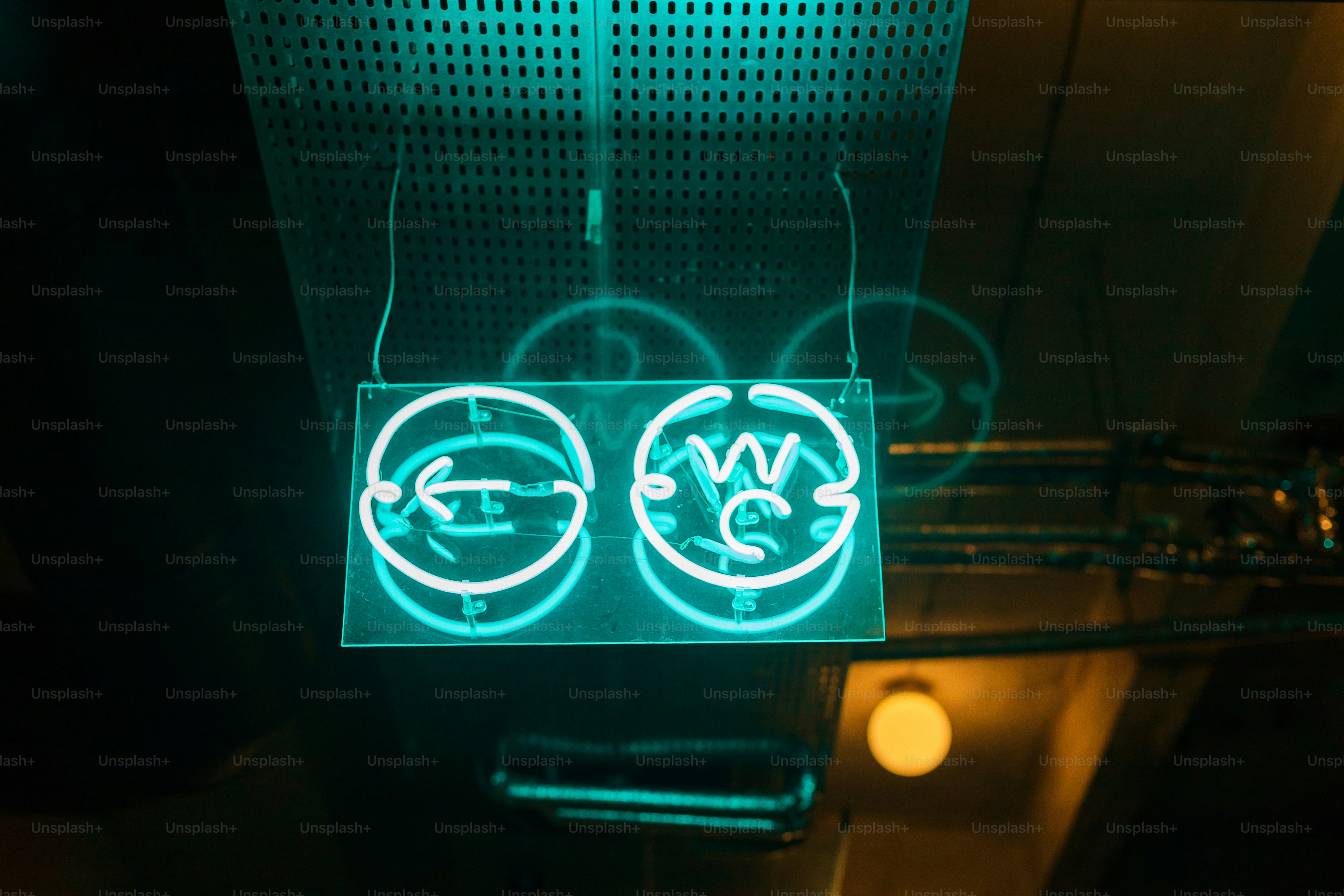 a neon sign that is hanging from a ceiling