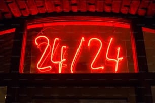a red neon sign that reads 42 / 24