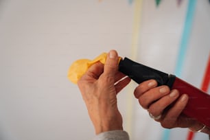 a close up of a person holding a yellow object